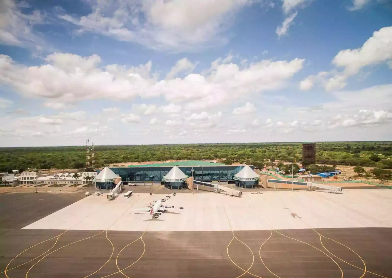 Aerial view airside of Victoria Falls International airport airplane in front of conical gates