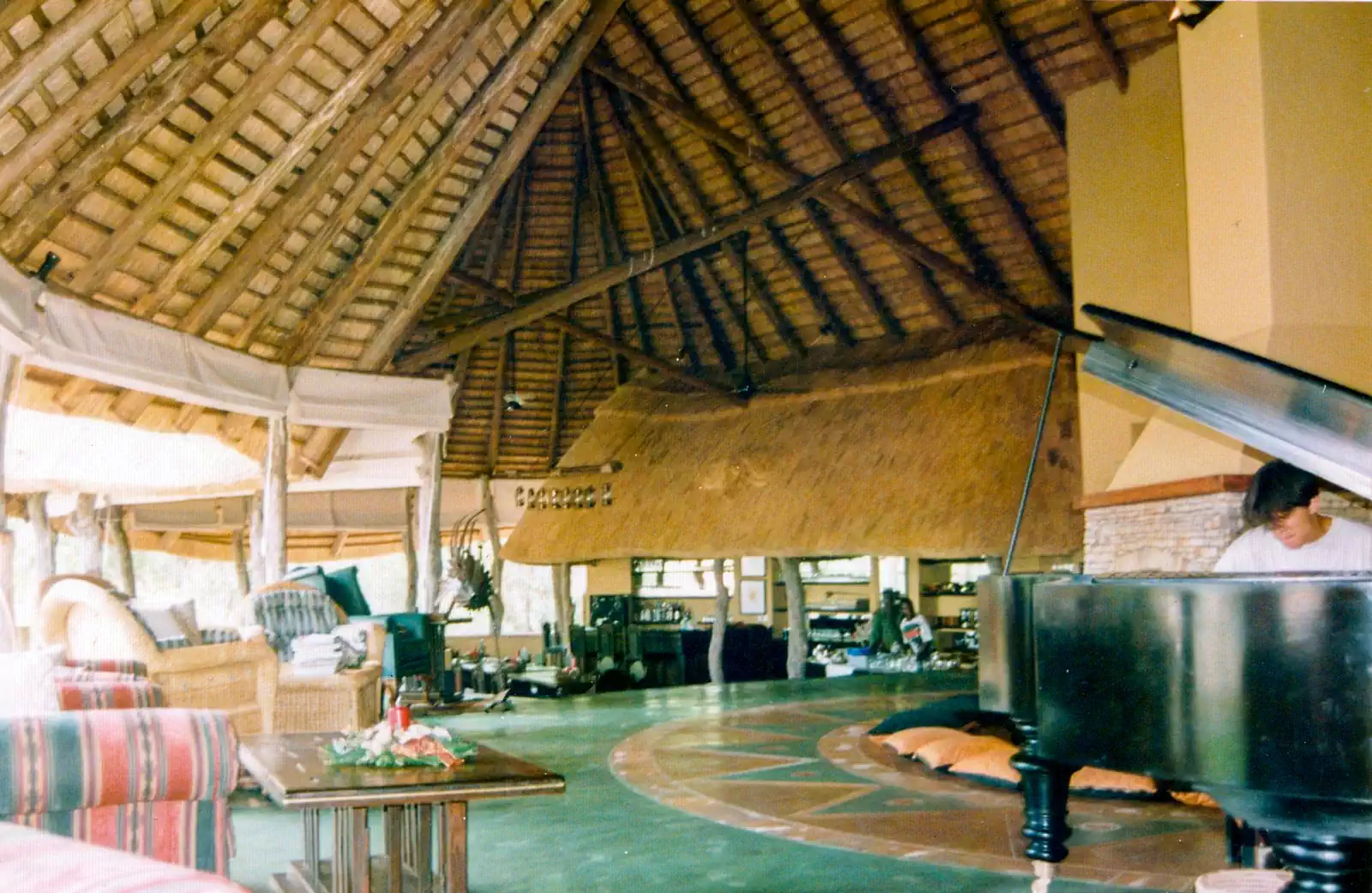 Traditional wooden gumpole structure and thatched roof in earthy interiors lodge