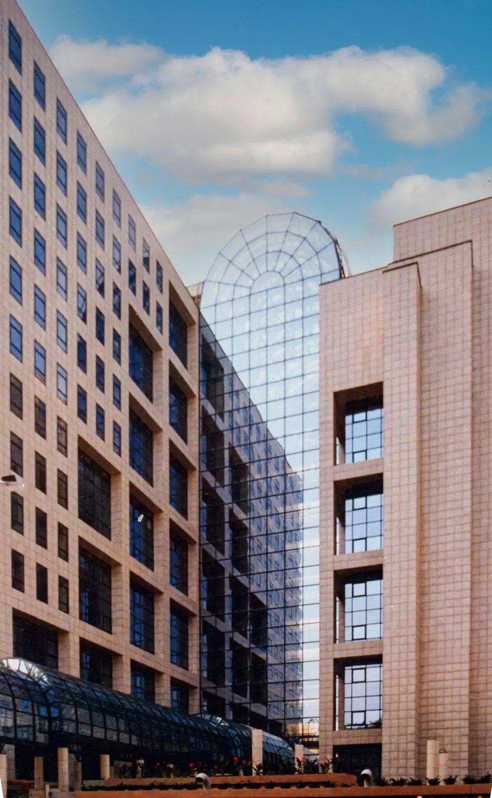 Modern glass and stone office building with modular design on podium