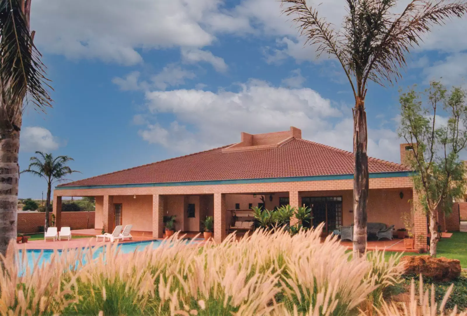 Contemporary symmetrical brick house with covered veranda in Gaborone, Botswana
