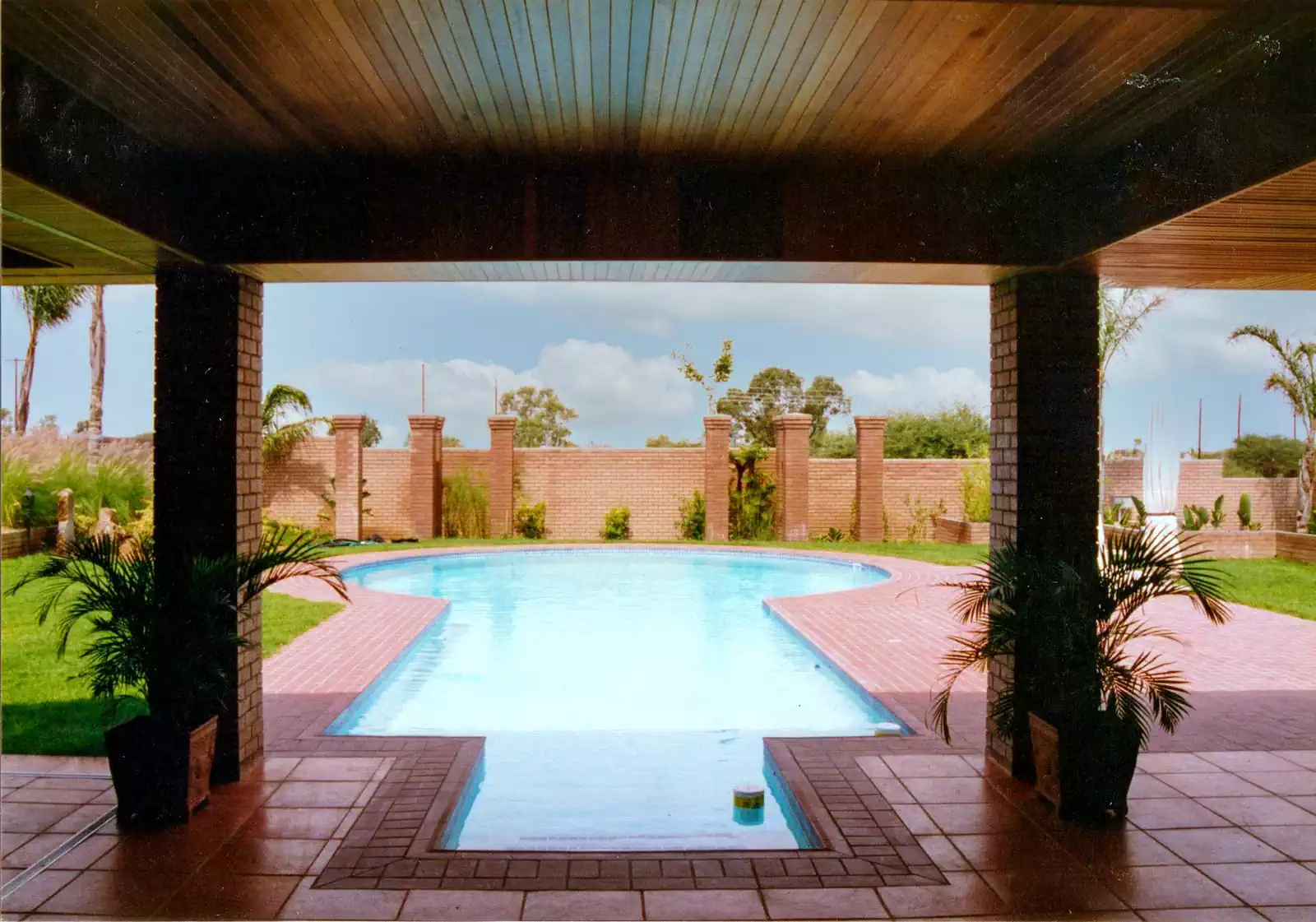 Contemporary symmetrical brick house with covered veranda in Gaborone, Botswana