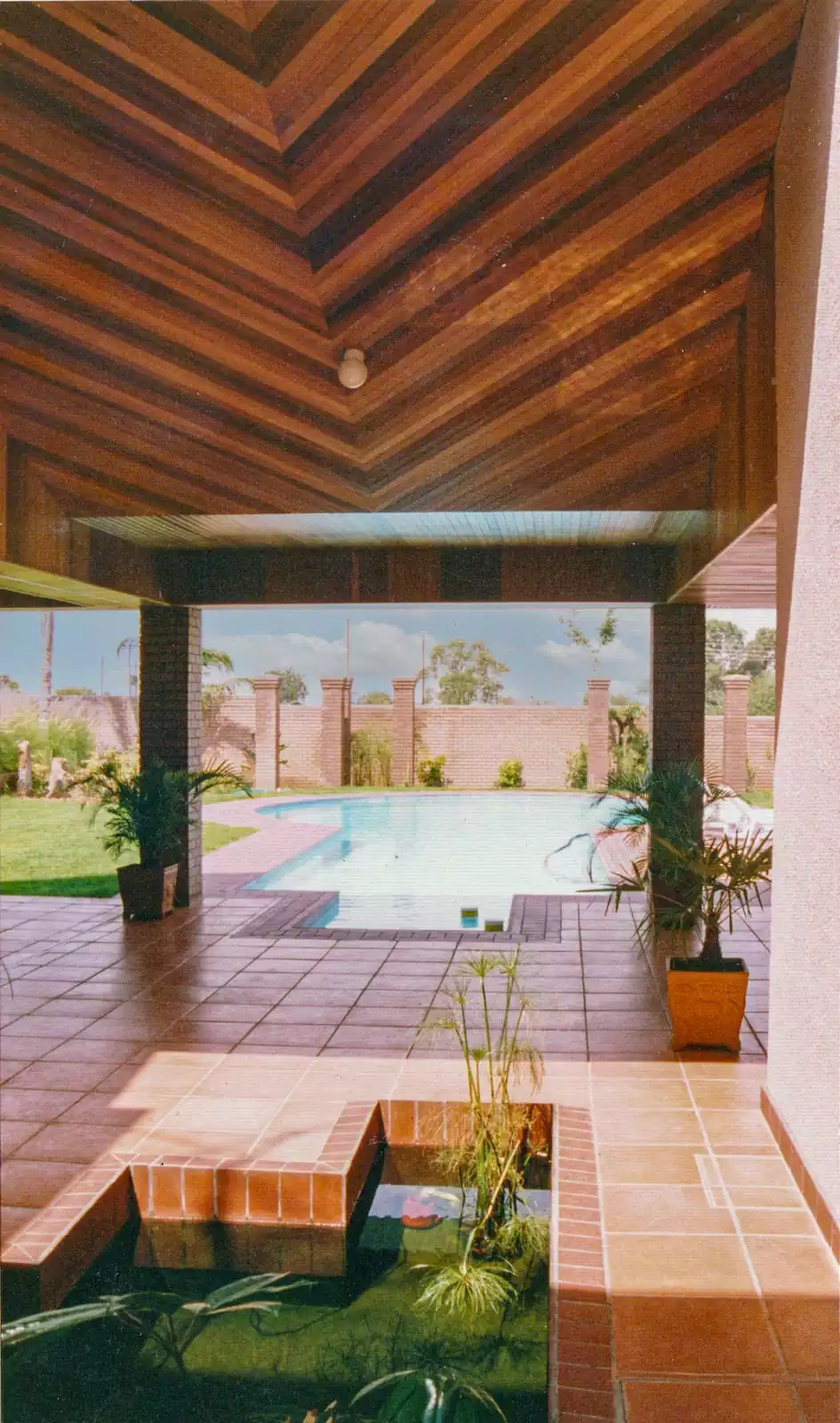 Symmetrical contemporary face-brick house with wooden trusses designed by Zimbabwe architect