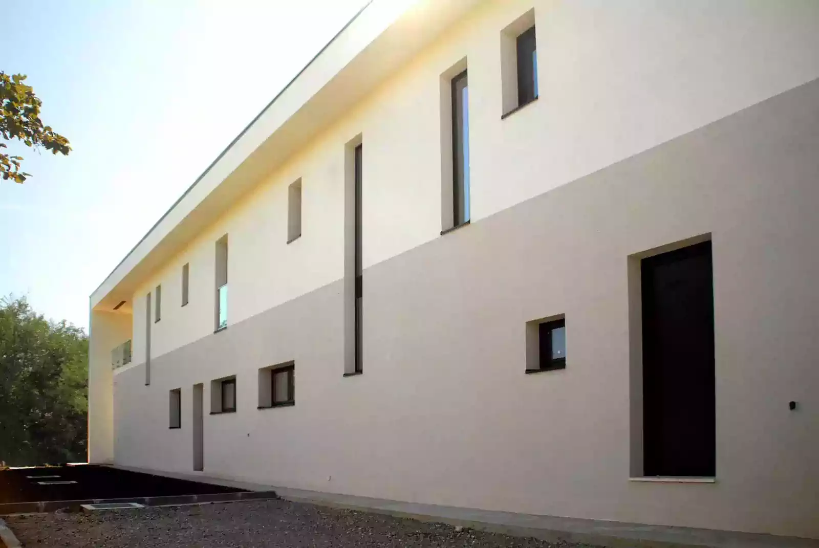 Rhythm of window and door openings on rear of house facing away from the sun. Design by architectural firm Harare