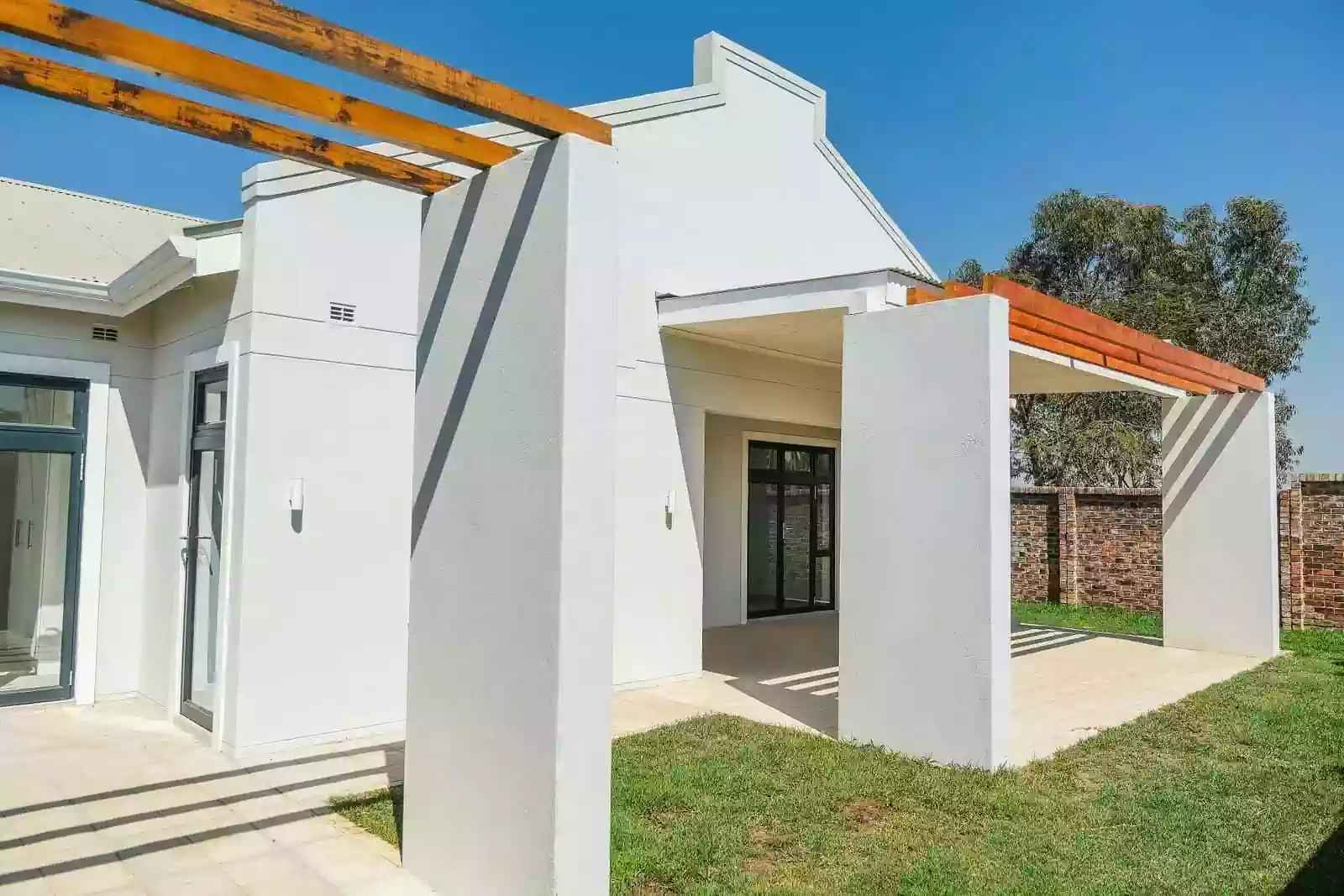 Back veranda with timber beams as pergola creating shade