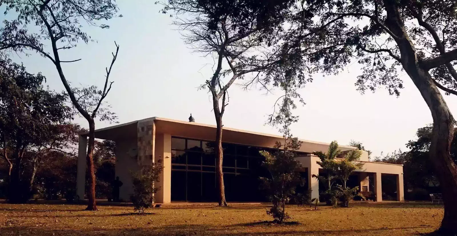 Sleek minimalist modern house design with large horizontal roofs and big overhangs covering veranda. Building design by Pantic Architects