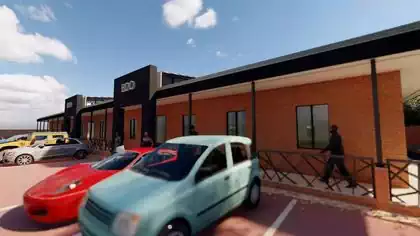 Covered shady walkway between offices and parked carks in modern facebrick building in Lusaka