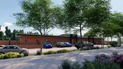 Simple modern commercial building with two pronounced entrances to shady walkway behind parking. Retail and Office design by Zim designers