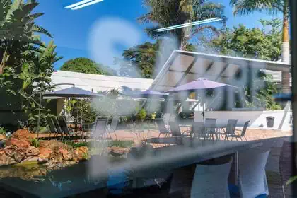Outside seating in front of cool steel canopy reflection in Sabre mirror detail