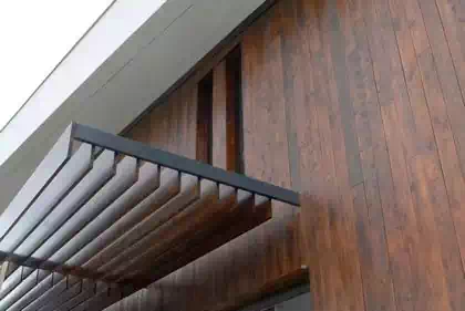 Wooden louvre detail to shade from sun on wooden facade of modern building