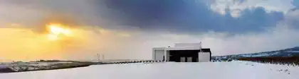 Temet building in snow covered fields blending in scenery in Serbia 