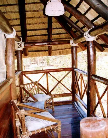 Veranda view of thatched roof Detema lodge main building with gumpoles by local architect