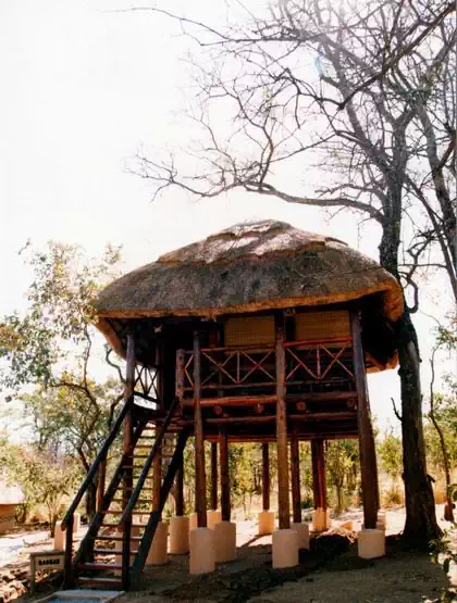 Veranda view of thatched roof Detema lodge main building with gumpoles by local architect