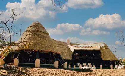 Large thatched roof entrance with engraved elephant lodge in Zimbabwe