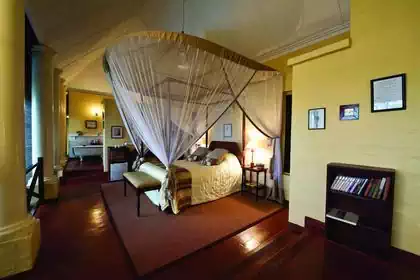 Luxurious colonial look lodge bedroom in Zambian lodge designed by architect 