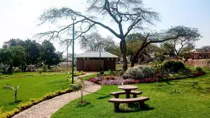 Plauqe and landscaping details vegetation and pebbles with building in background in NSSA Chipinge park