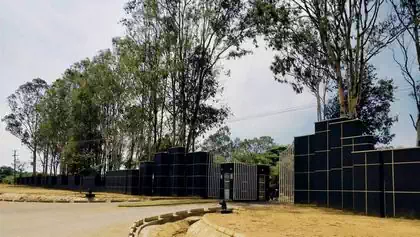 Monumental granite entrance to graveyard at Serene newly built graveyard with tombstones in Leopard's Hill Memorial Park, Lusaka 