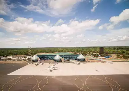 Aerial view airside of Victoria Falls International airport airplane in front of conical gates