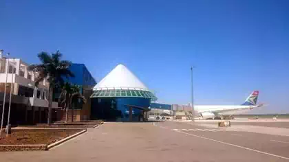 Conical glass gate building with finger to airplane at Victoria Falls International Airport