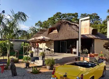 Fun coffee shop modern interior design with wooden cladding and wooden elements by architect in Harare