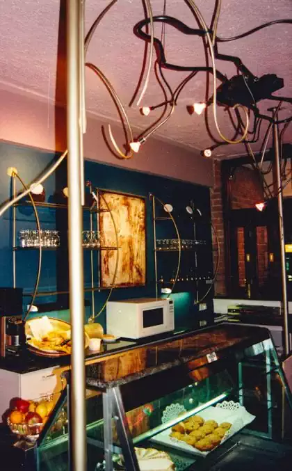 Fun creative wrought iron shelves and details in coffee shop design by Pantic Architects