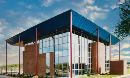 Modern facebrick and glass minimalist office building with large overhang to protect against sun and rain