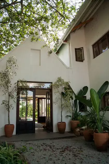 Continous view through house to entrance from pool. Cape dutch house designed by harare architect