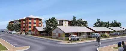 Multicoloured four story apartment buildings behind small houses in foreground. Residential design by architect from Harare