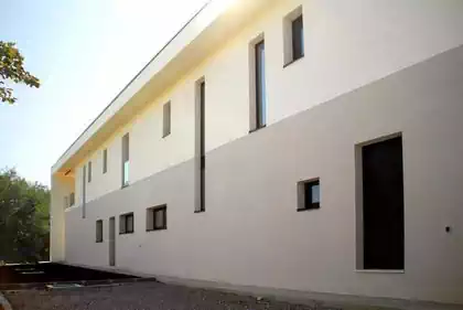 Rhythm of window and door openings on rear of house facing away from the sun. Design by architectural firm Harare