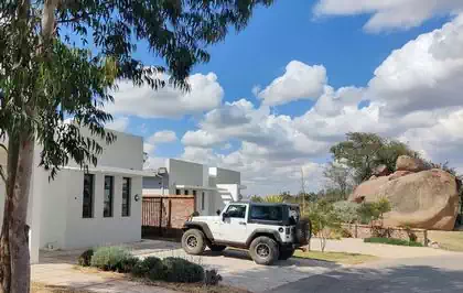 Modern houses next to vegetation and boulders in Arlington Harare