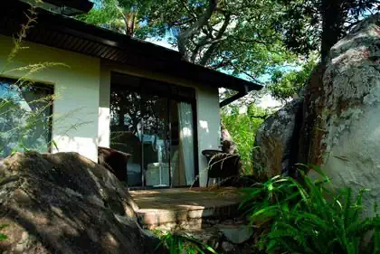 Intimate shaded veranda in between rocks and trees in private house