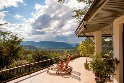 Amazing verandah deck with view and seating amongst tree canopies and treetops. House design by harare architect