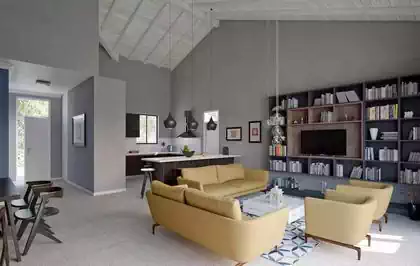 Spectacular double volume open plan living area in cape dutch styled house. Monochromatic decorations with yellow furniture. White rafters and tongue and groove wooden cladding