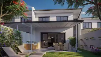 Townhouse backyard with loungers, dining and cooking area covered by timber roof which provides shade and comfort