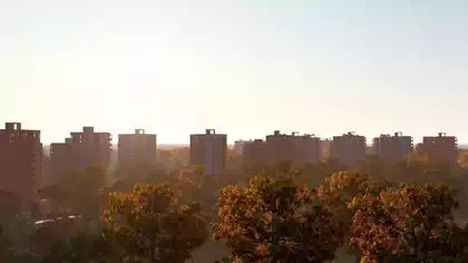 Dusk view of apartment buildings and trees in Mbare Flats town planning design by local architect