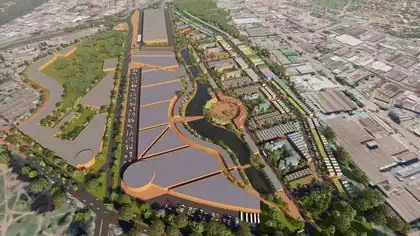 Industrial,commercial,residential buildings following river amongst trees