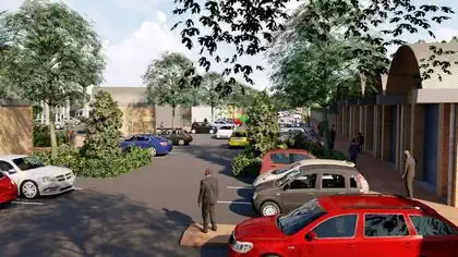 Street view of workshops, cars and street within vegetation