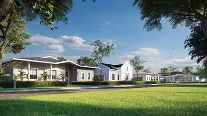 Stret view of housing cluster showing multiple houses next to each other among trees and greenery.